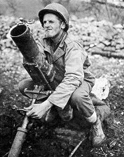 Gunner adjusting elevation of mortar, location unknown.